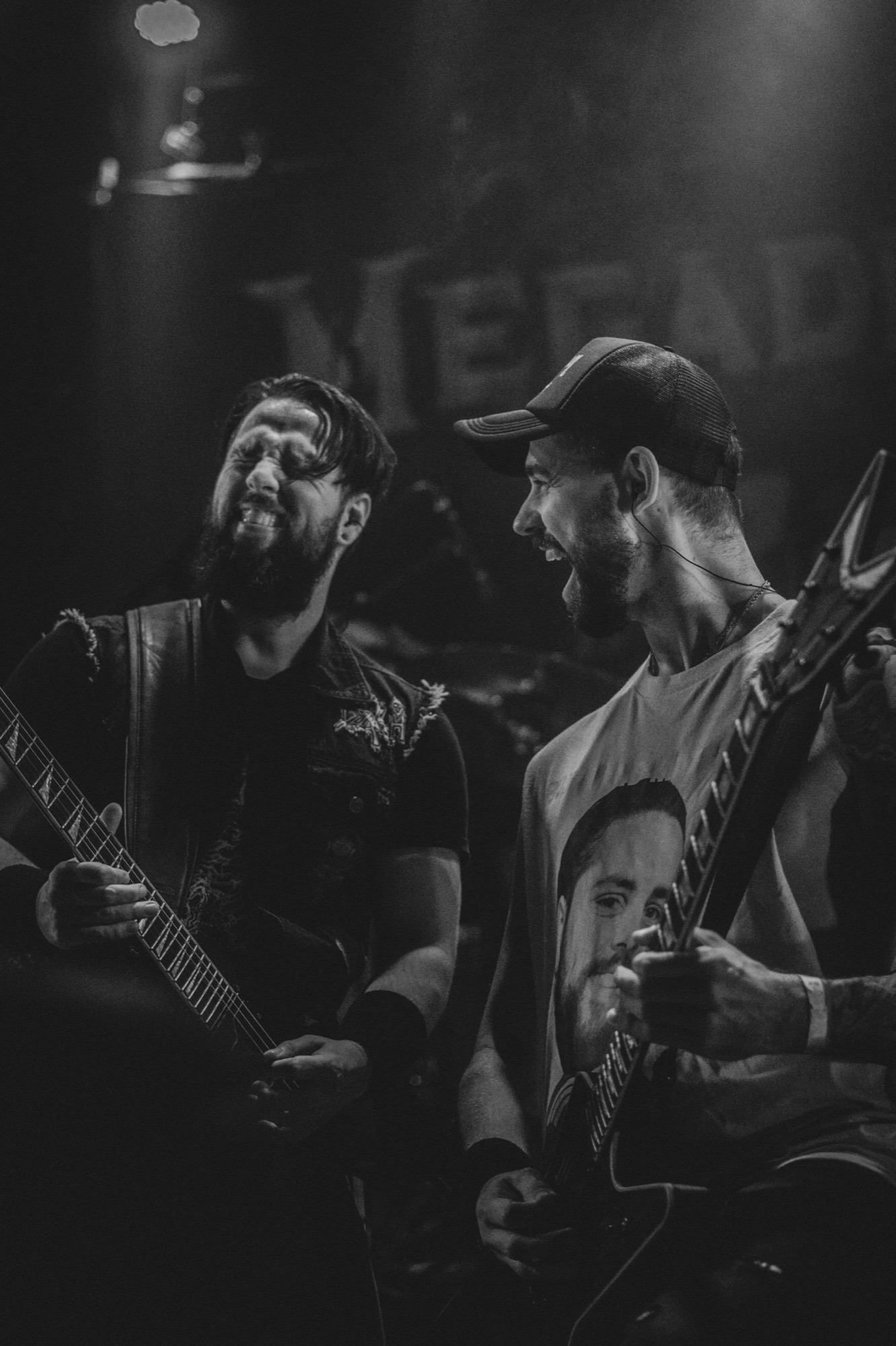 Two guitarists performing together