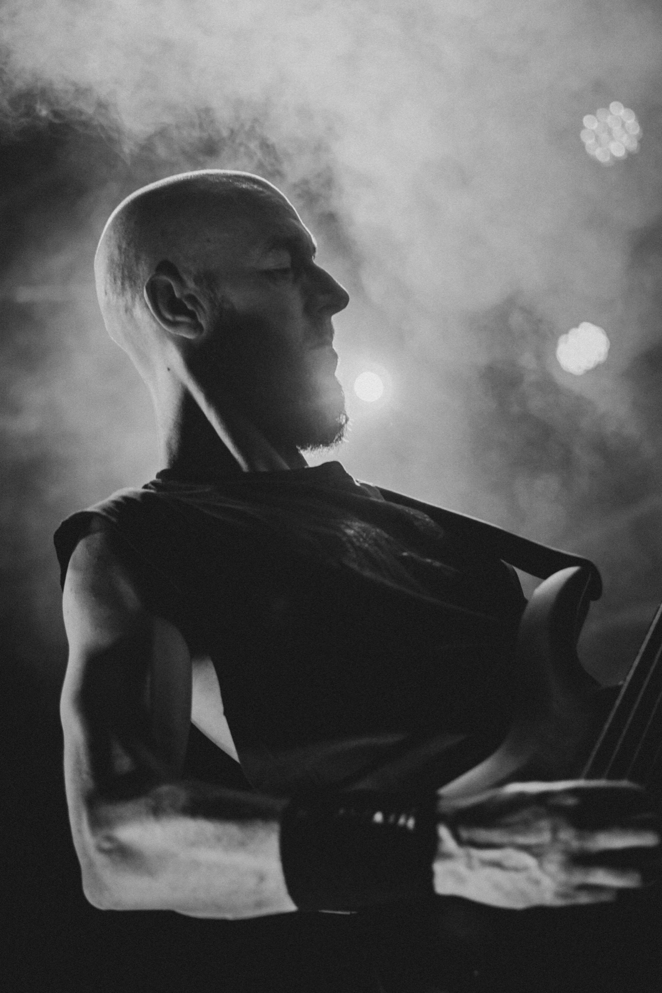 Bassist in smoke and backlight