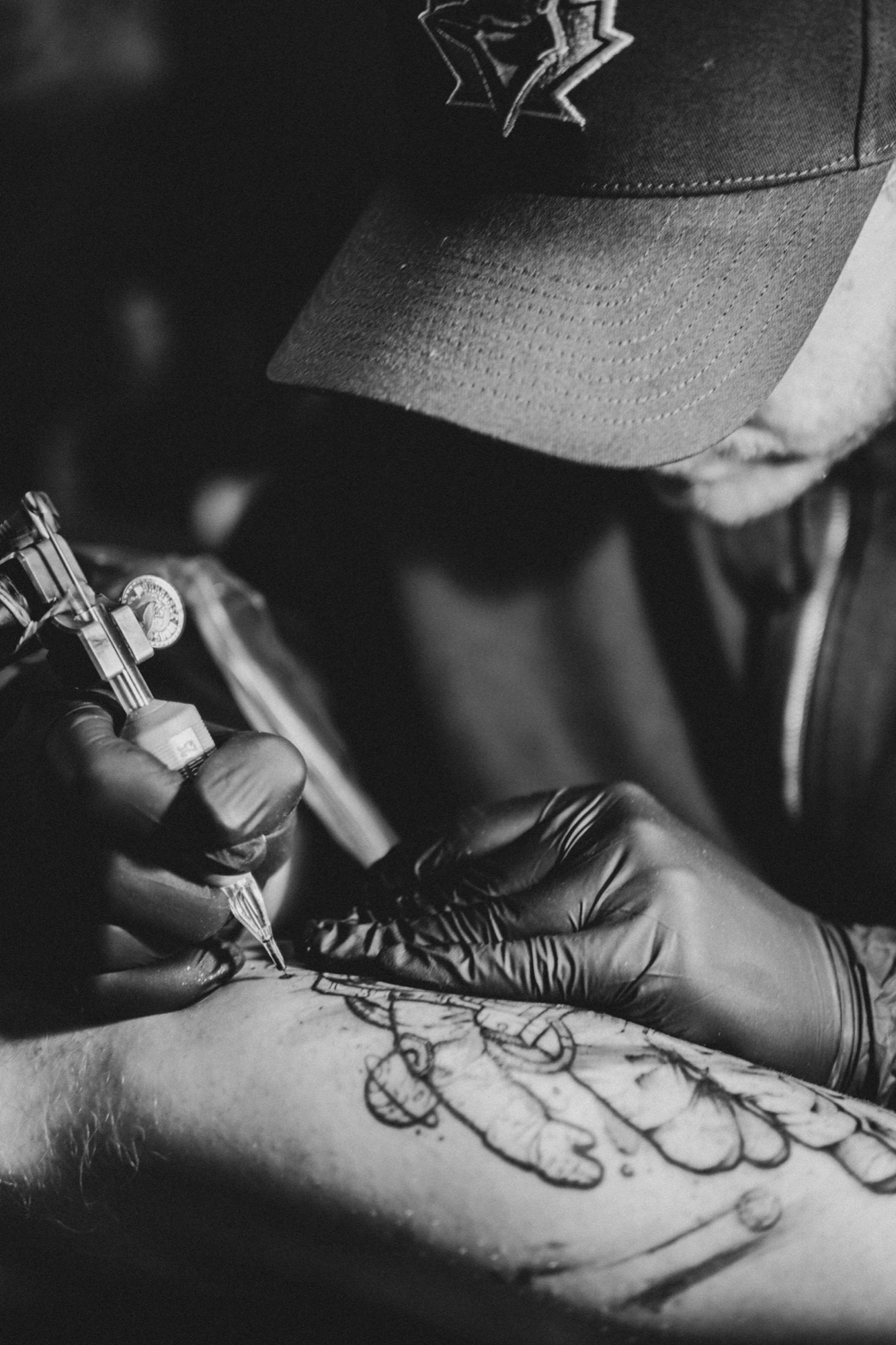 Close detail of the tattoo needle and hands