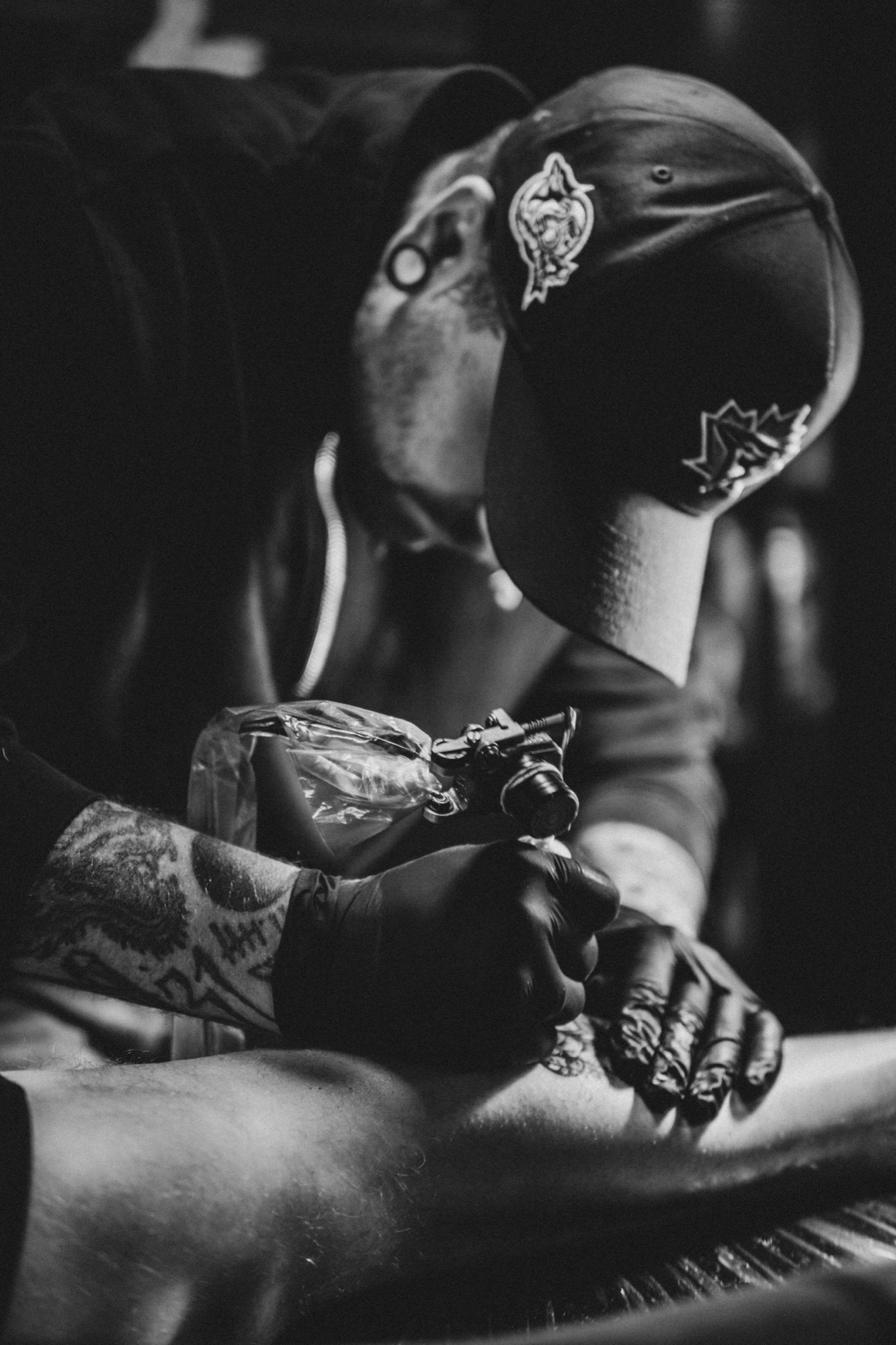 Tattoo artist concentrating on his work