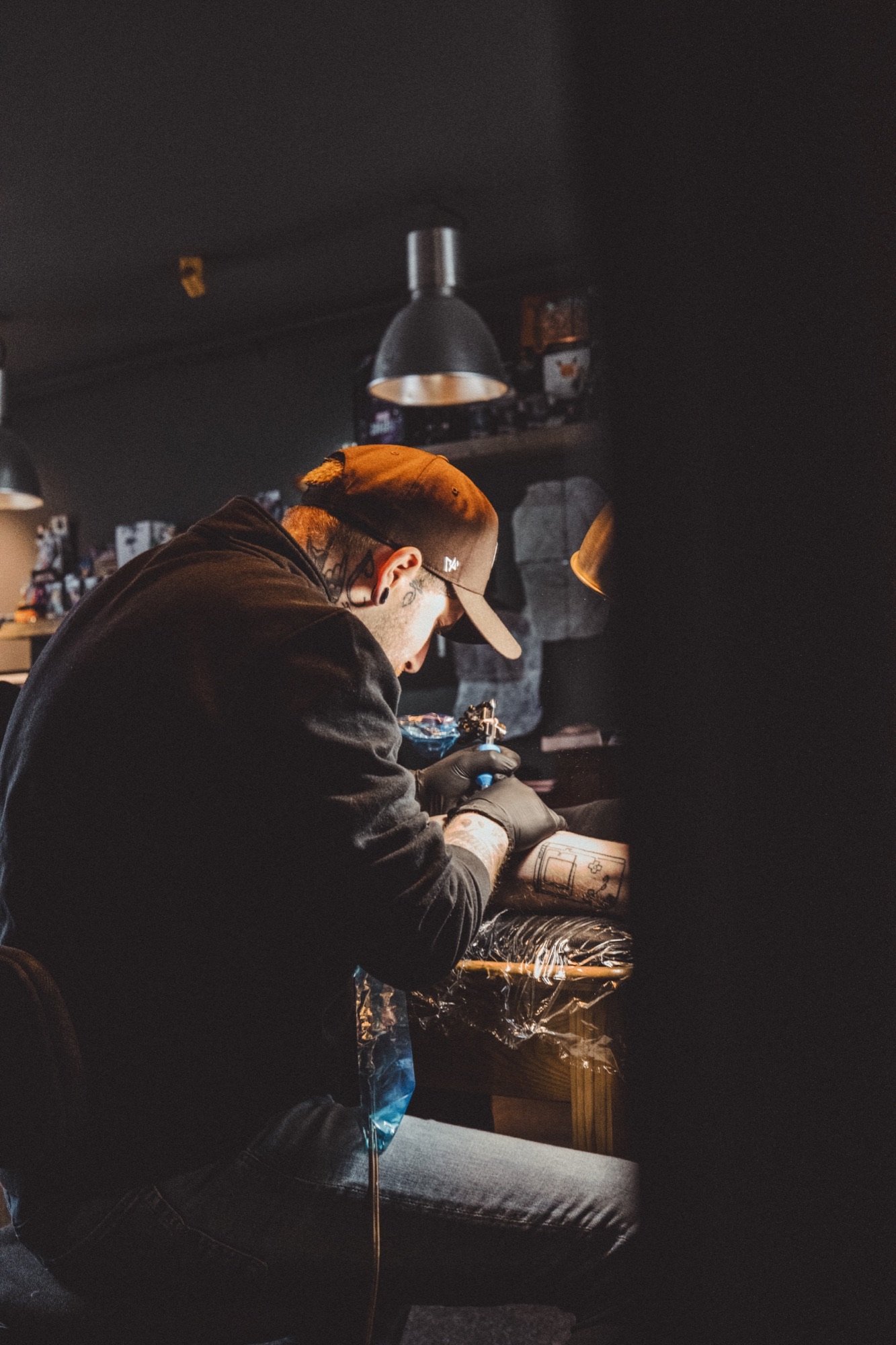Tattoo artist in warm studio light